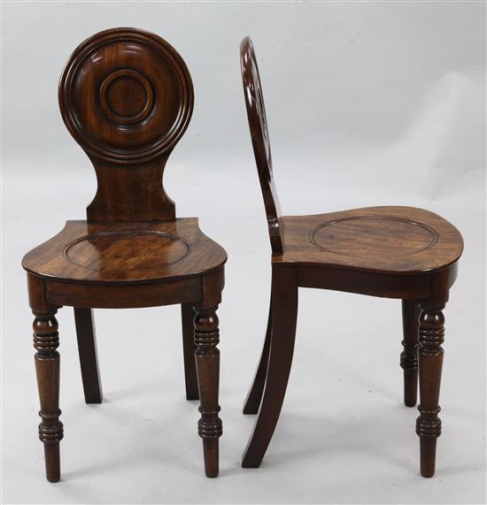 A pair of Regency mahogany hall chairs, W.1ft 4in. H.2ft 8in.